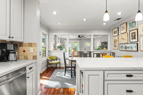 a living room with stainless steel appliances kitchen island granite countertop furniture and a kitchen view