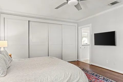 a bedroom with a bed and a flat screen tv