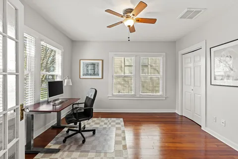 a view of a workspace with furniture and a window