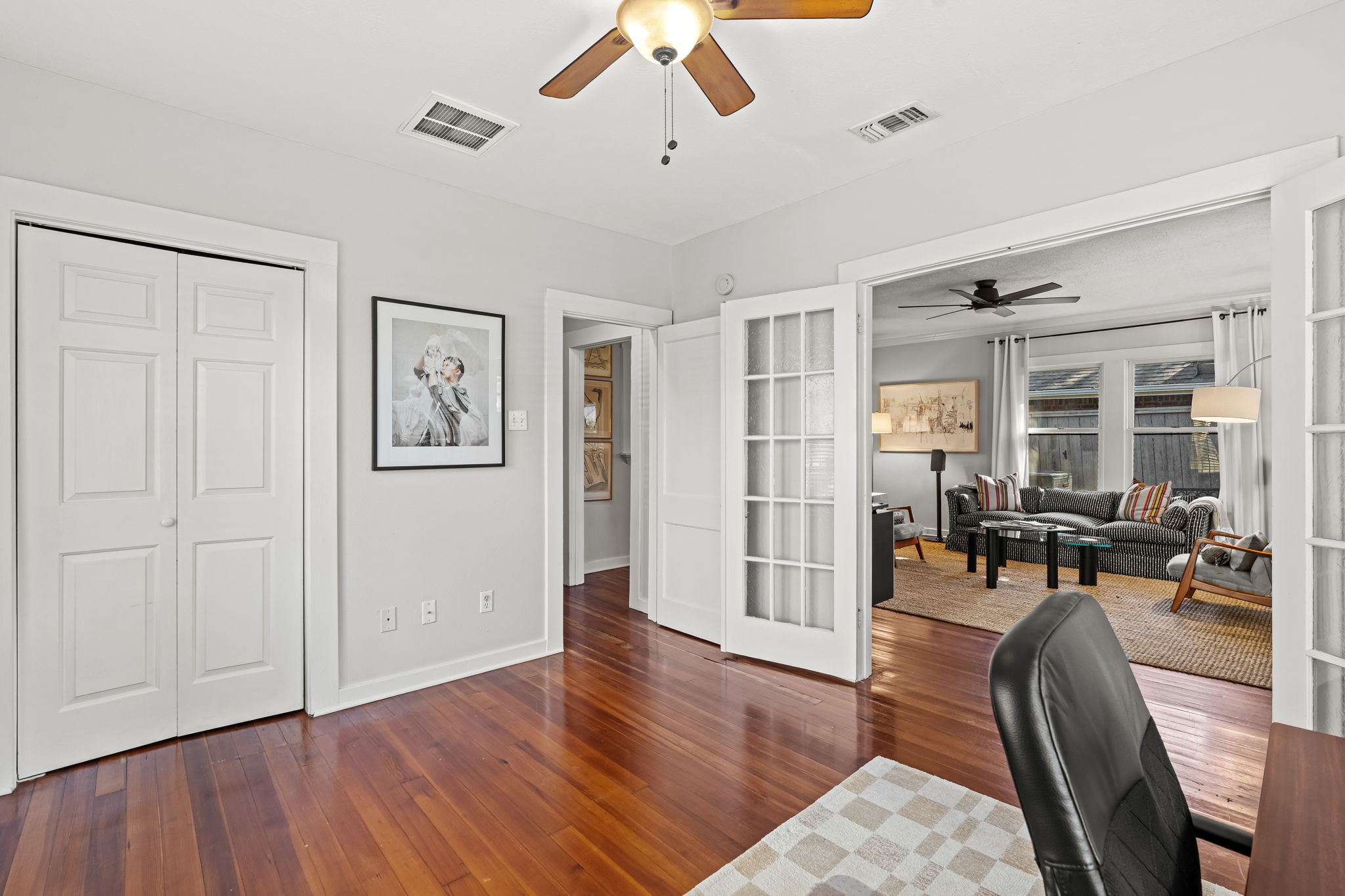 805 Ralfallen Street Houston, TX 77008 - Photo 18 of 32 Front bedroom with hardwood floors, ample natural light, and French doors that open to the main living area, creating a bright and flexible space.