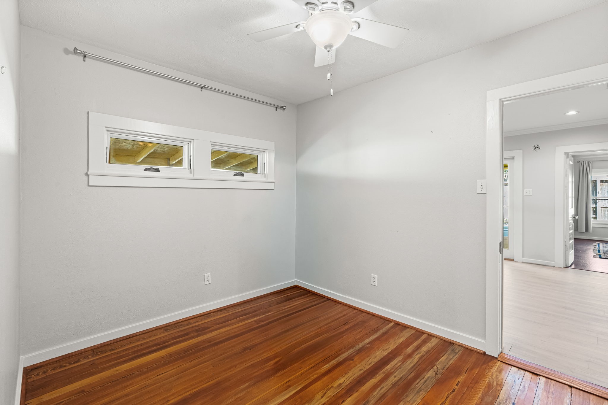 805 Ralfallen Street Houston, TX 77008 - Photo 19 of 32 Secondary bedroom with hardwood floors and natural light, offering a comfortable and versatile space.