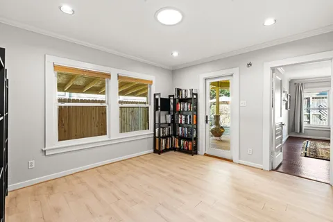 an empty room with a window and walk in closet