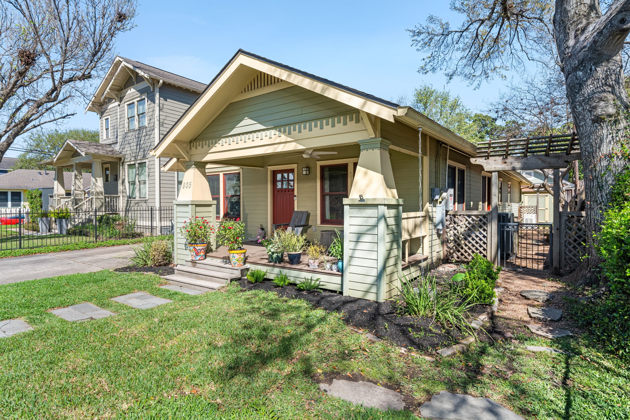 805 Ralfallen Street Houston, TX 77008 - Photo 2 of 32 This charming Heights bungalow showcases classic Craftsman-style architecture with a welcoming covered front porch supported by tapered columns and detailed gabled rooflines.