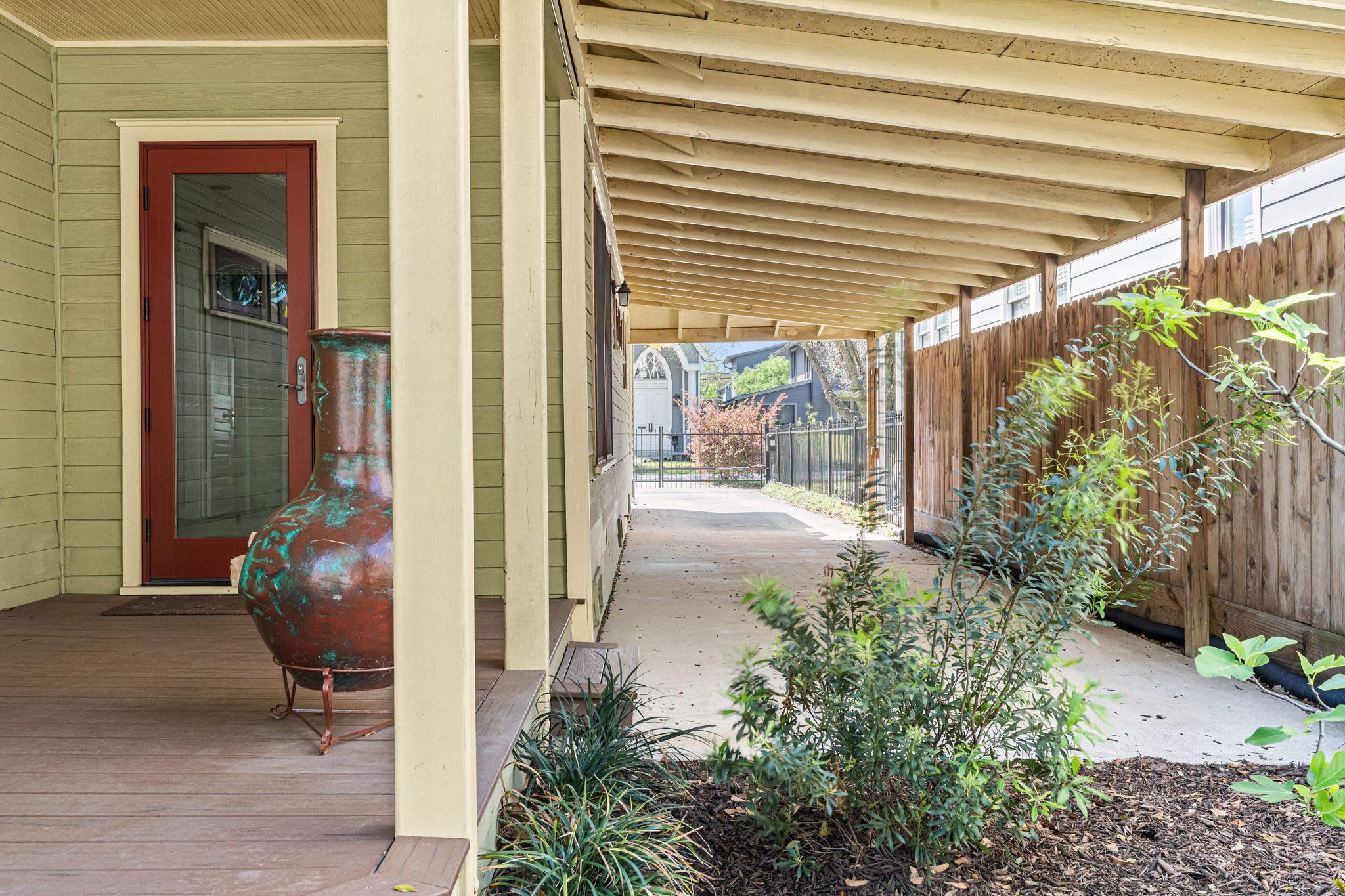805 Ralfallen Street Houston, TX 77008 - Photo 25 of 32 Covered carport with extended drive-through access leading to a spacious covered back patio, offering convenient parking and shaded outdoor living.