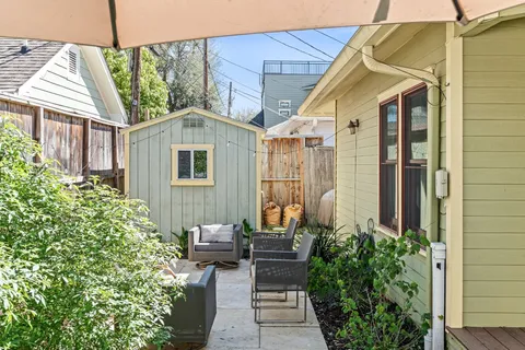 a view of a patio with a table and chairs