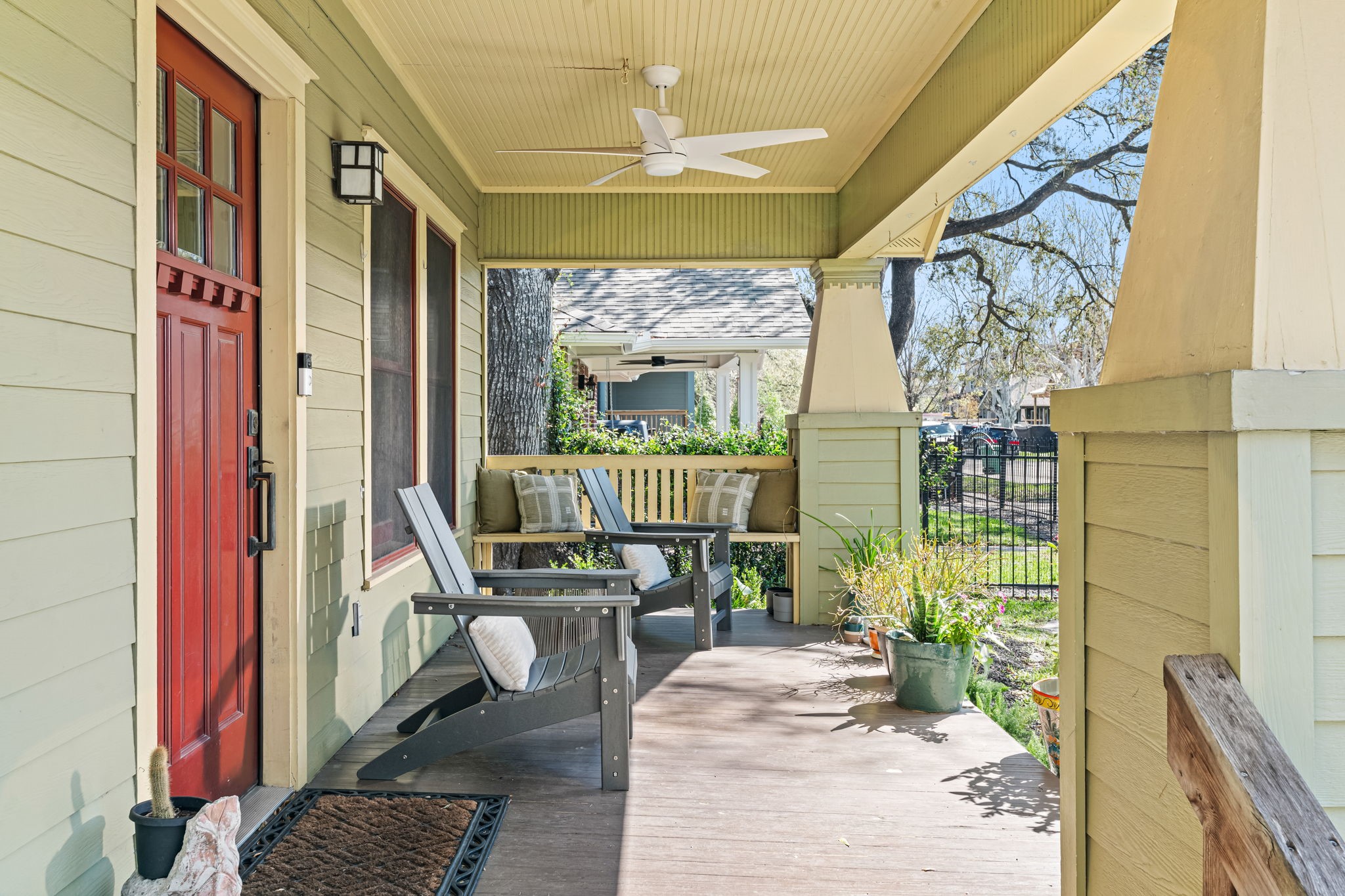 805 Ralfallen Street Houston, TX 77008 - Photo 4 of 32 A spacious covered front porch with classic Craftsman details offers a relaxing spot to unwind, complete with ceiling fan, comfortable seating, and peaceful views of the front yard and neighborhood.