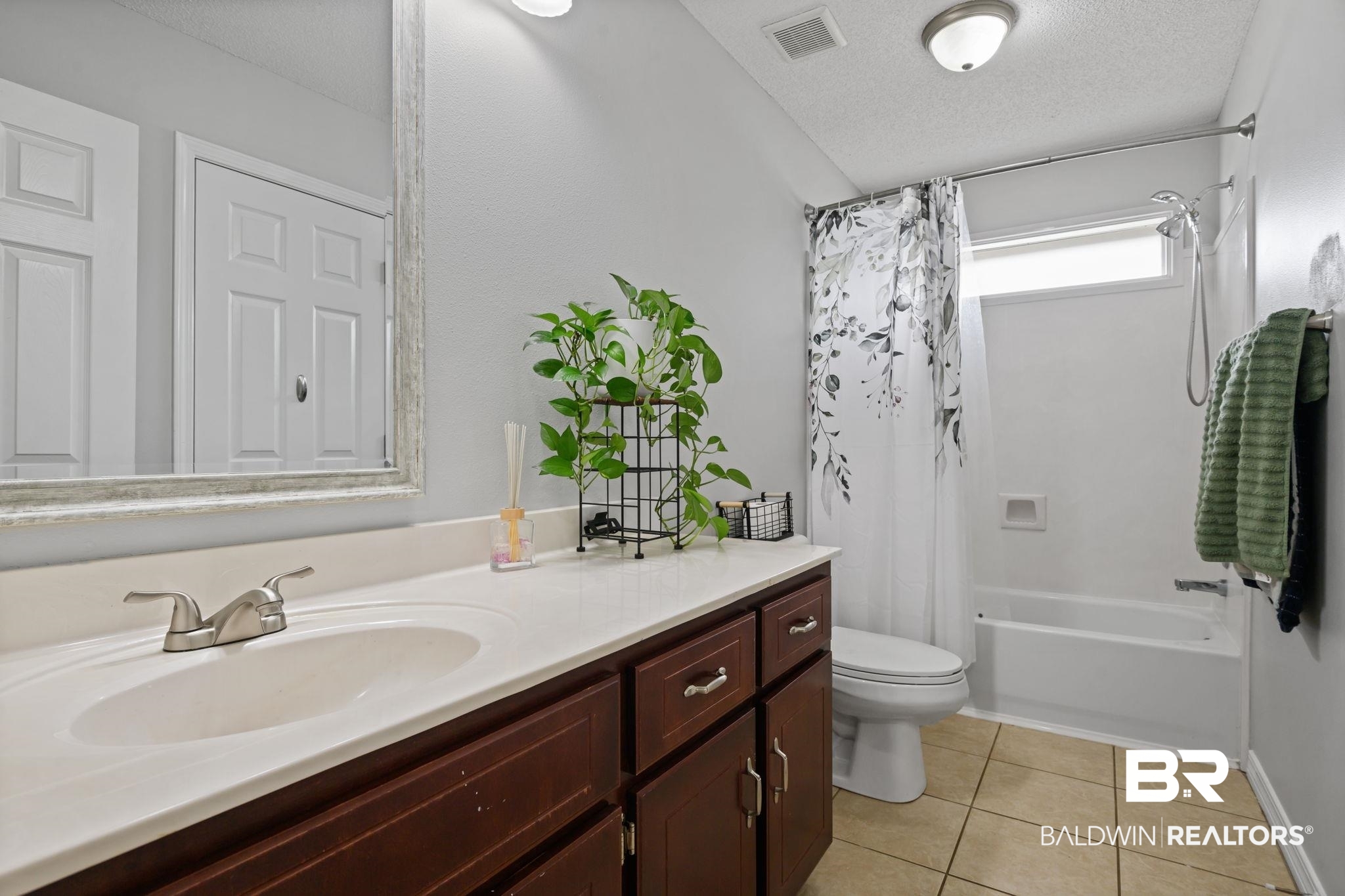 9422 Labrador Run South Mobile, AL 36695 - Photo 26 of 36 Bathroom featuring a vanity with dark wood-finish cabinetry, a white countertop, and an undermount sink