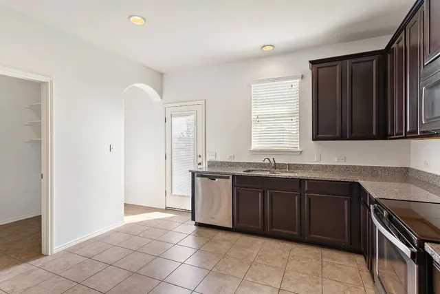 a kitchen with a refrigerator sink and microwave