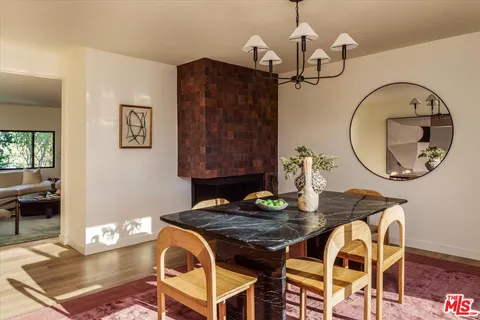 a view of a dining room with furniture and a chandelier
