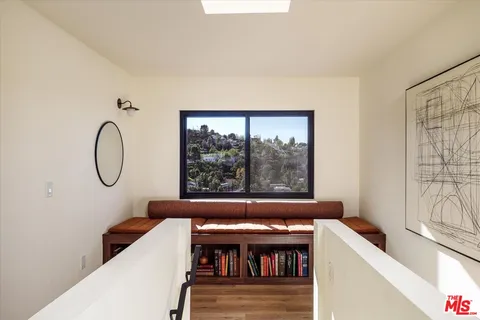 a view of a room with furniture and a window