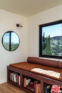 a living room with a couch and a floor to ceiling window