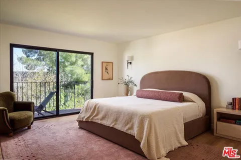 a bedroom with a bed and a couch