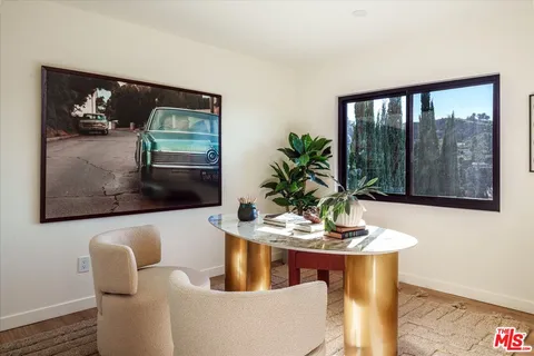 a dining room with furniture and window