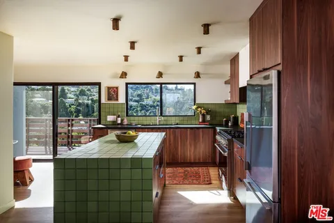 a dining room with furniture and a large window