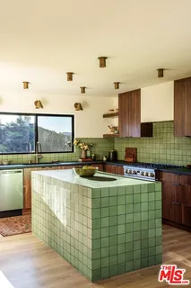 a kitchen with a sink and a stove top oven