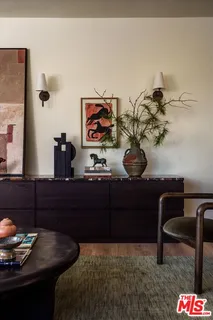 a living room with couch and a potted plant