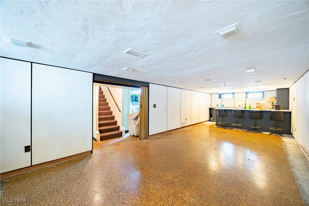 920 Clinton Avenue Cleveland, OH 44121 - Photo 14 of 14 Basement featuring a textured ceiling and bar
