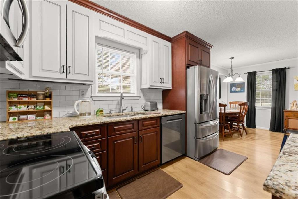 3322 Cheek Pulliam Road Royston, GA 30662 - Photo 11 of 61 a kitchen with stainless steel appliances granite countertop a refrigerator stove and sink