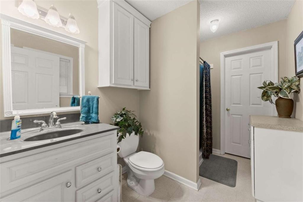 3322 Cheek Pulliam Road Royston, GA 30662 - Photo 16 of 61 a bathroom with a sink a toilet and a mirror