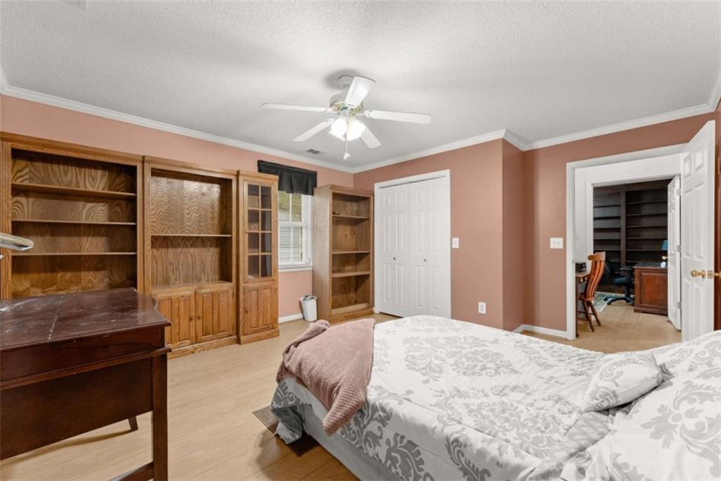 3322 Cheek Pulliam Road Royston, GA 30662 - Photo 20 of 61 a bedroom with a large bed and a chandelier