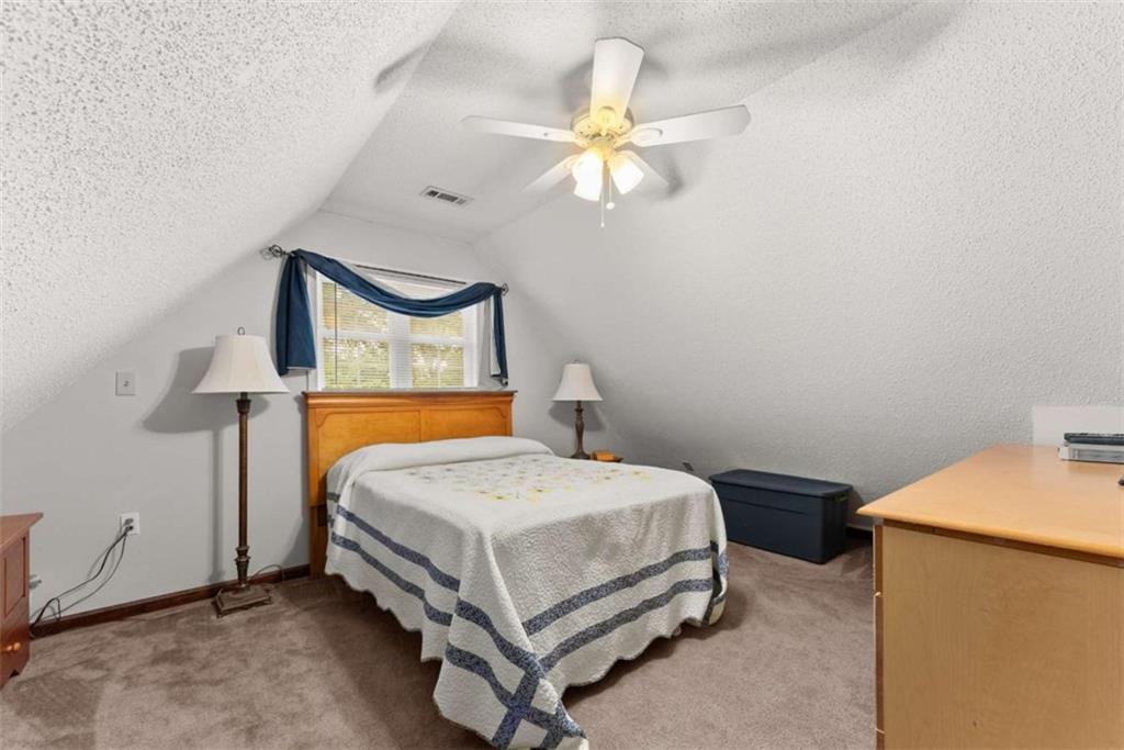 3322 Cheek Pulliam Road Royston, GA 30662 - Photo 21 of 61 a bedroom with a bed and a chandelier