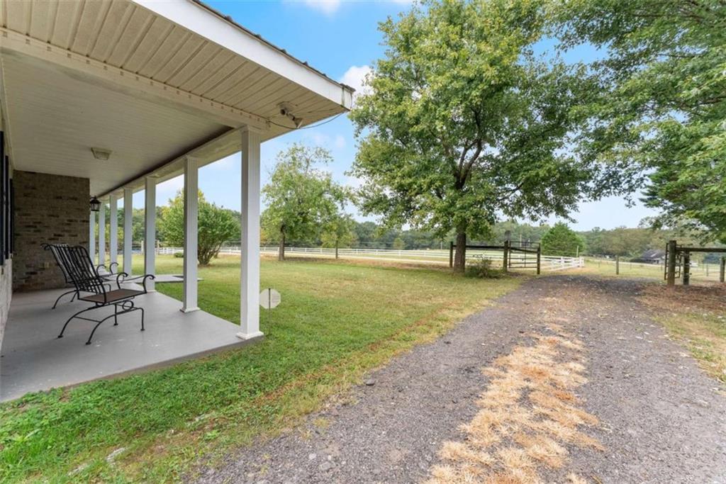 3322 Cheek Pulliam Road Royston, GA 30662 - Photo 34 of 61 a view of a yard with a table and chairs under an umbrella