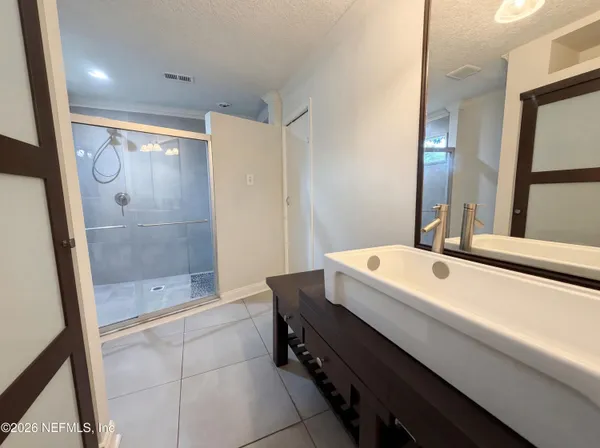 a bathroom with a bathtub and a shower