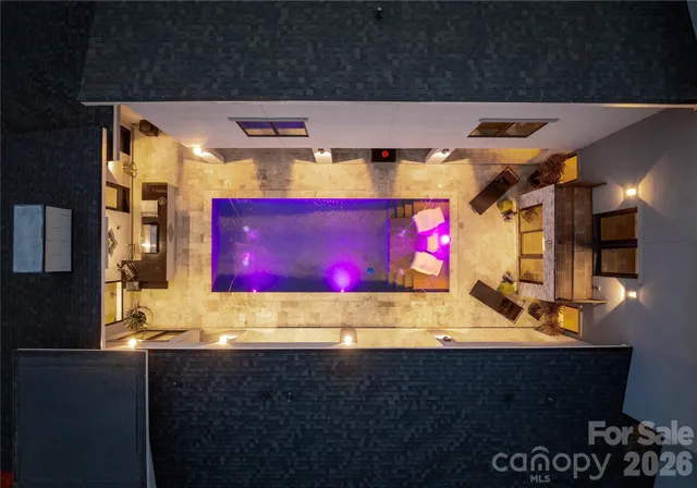 a living room with pool table furniture and a flat screen tv