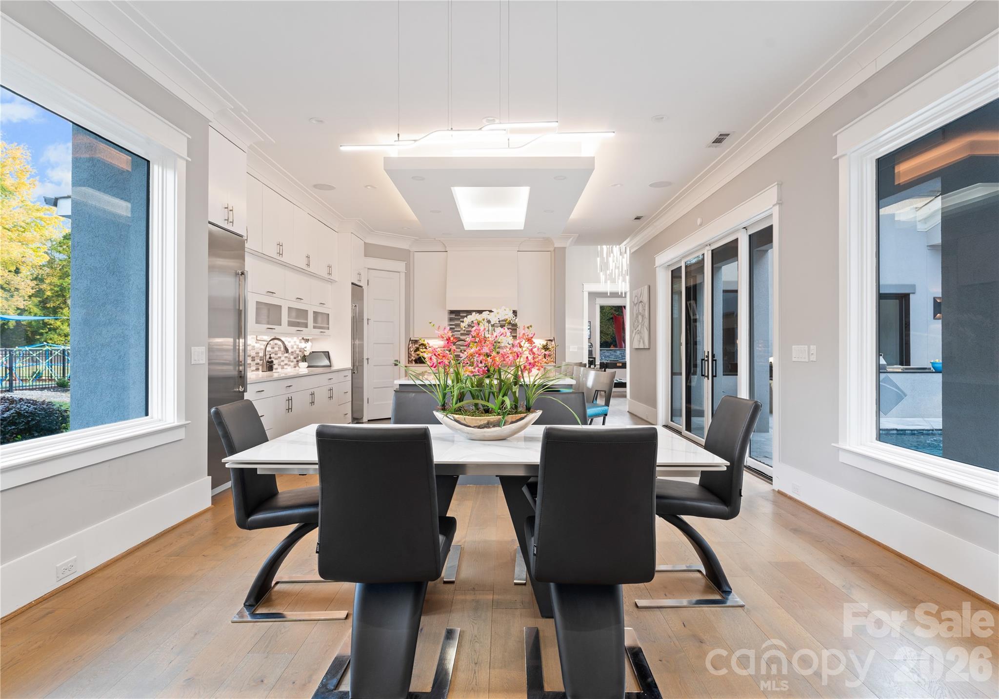 15700 Youngblood Road Charlotte, NC 28278 - Photo 13 of 41 a dining room with furniture potted plants and wooden floor