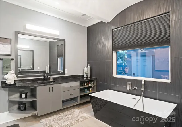 a view of a patio with couches table and chairs with wooden floor and fence