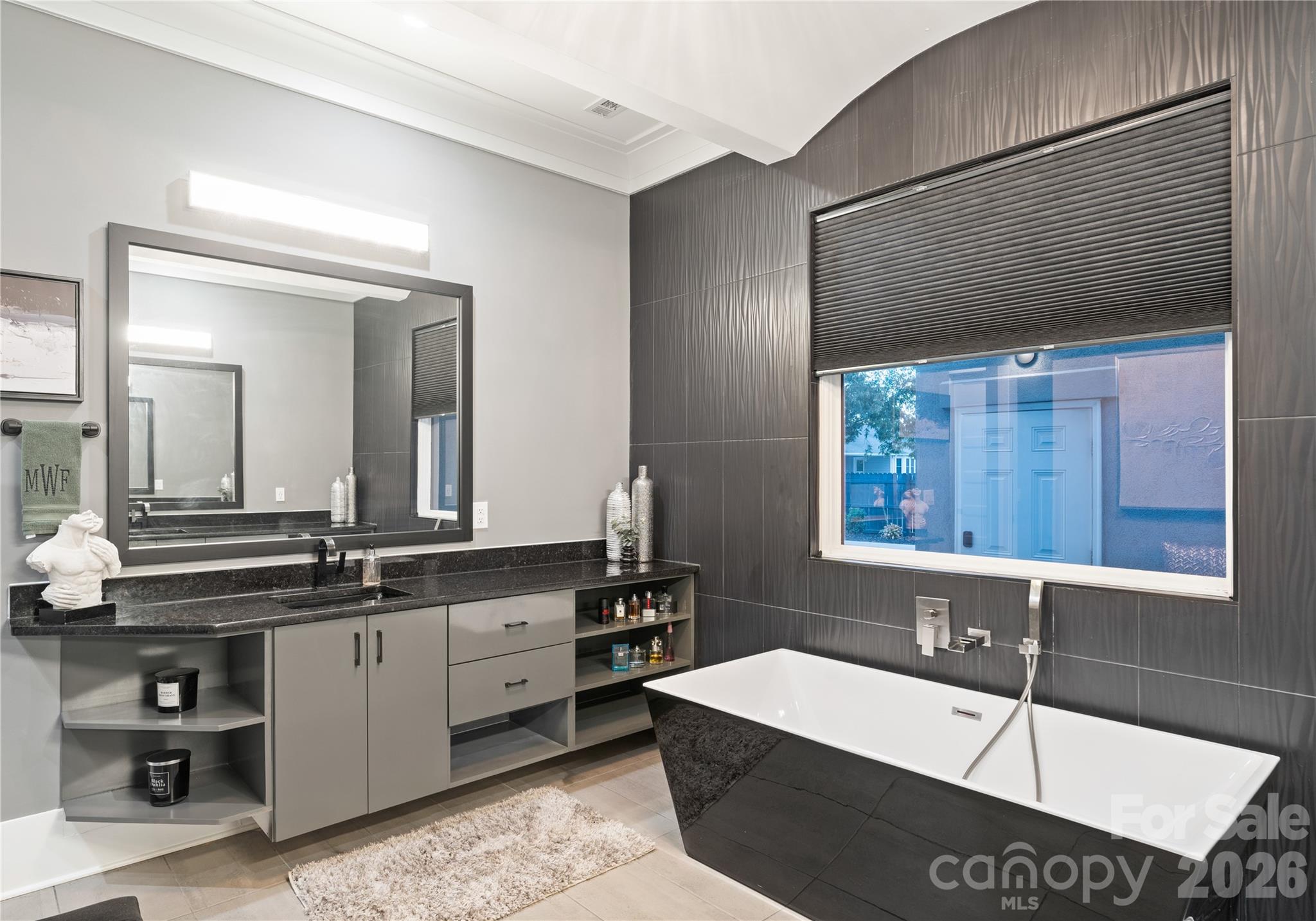 15700 Youngblood Road Charlotte, NC 28278 - Photo 9 of 41 a bathroom with a bathtub a sink and a window