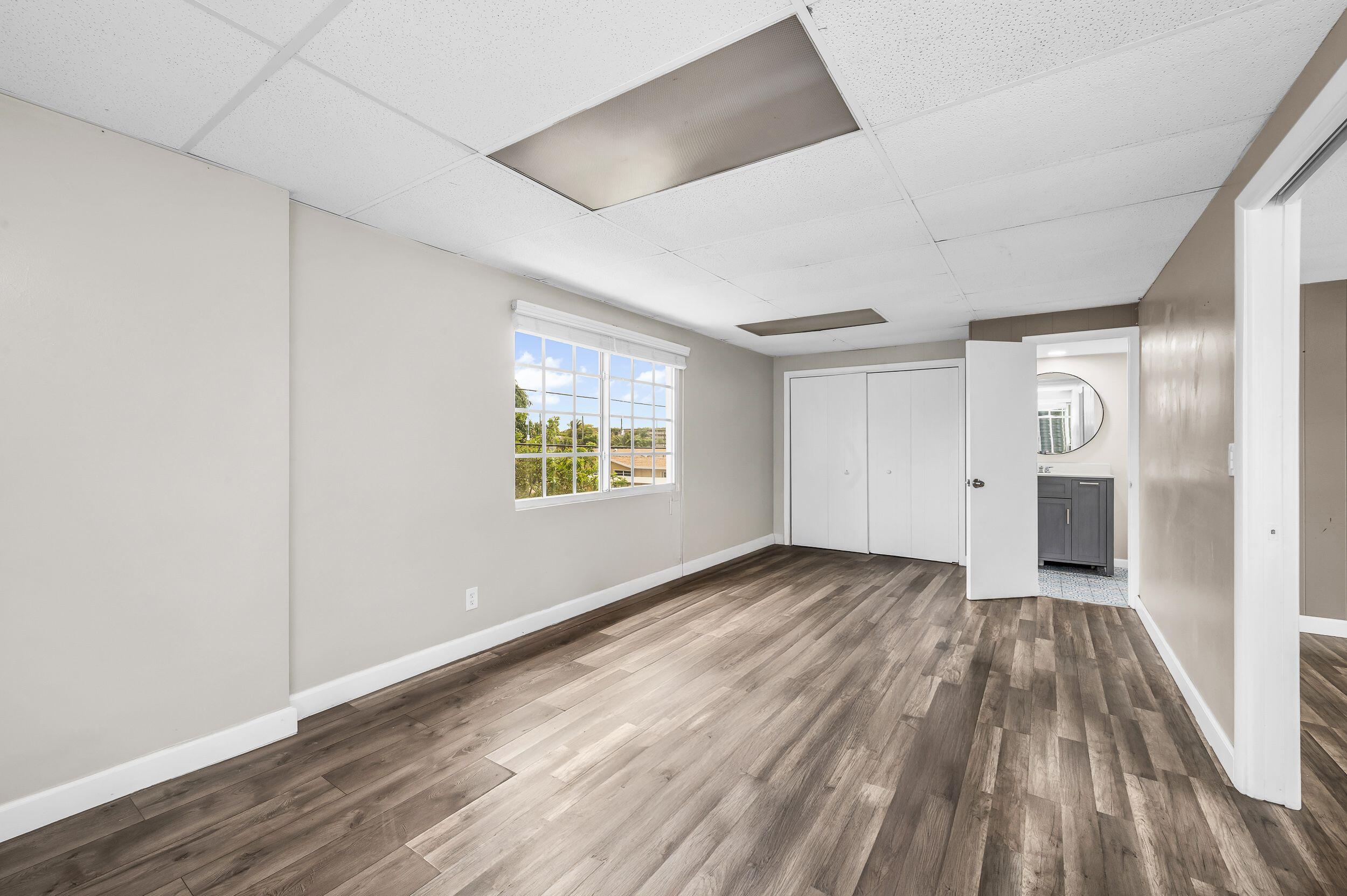 4734 Jefferson Street Hollywood, FL 33021 - Photo 54 of 68 an empty room with wooden floor and windows