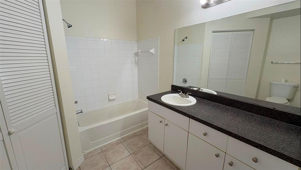 6348 Raleigh Street, Unit 1304 Orlando, FL 32835 - Photo 10 of 20 a bathroom with a sink and a mirror