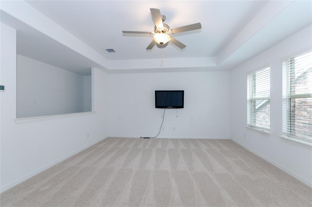1222 Sequoia Lane Princeton, TX 75407 - Photo 10 of 29 Game room with a tray ceiling, light colored carpet, ceiling fan, and baseboards