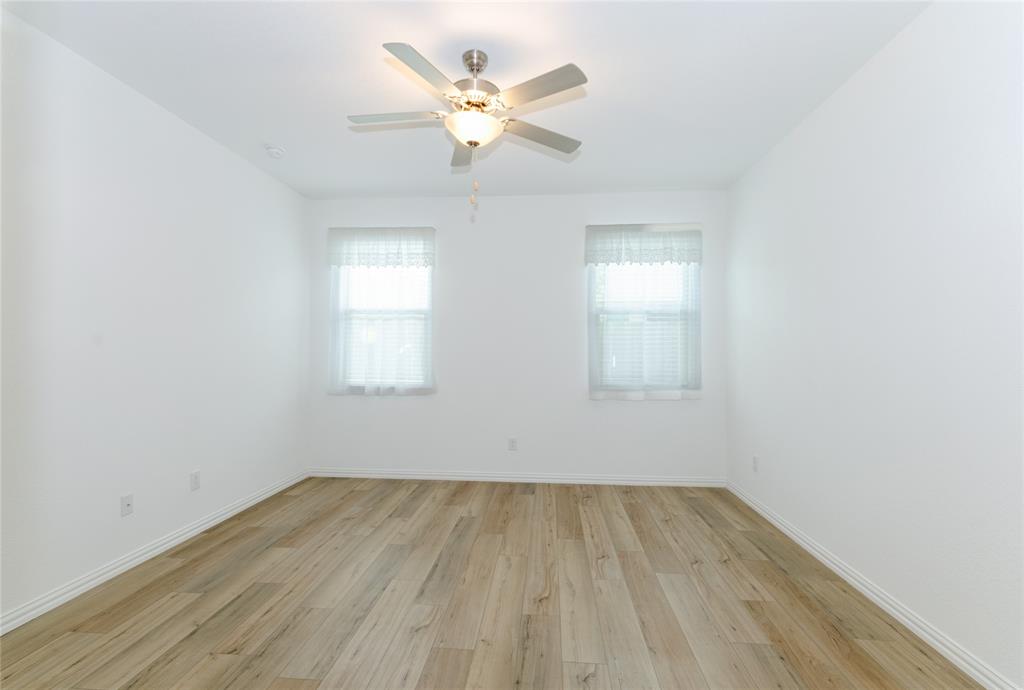 1222 Sequoia Lane Princeton, TX 75407 - Photo 12 of 29 Bedroom featuring healthy amount of natural light, light wood-type flooring, ceiling fan, and baseboards