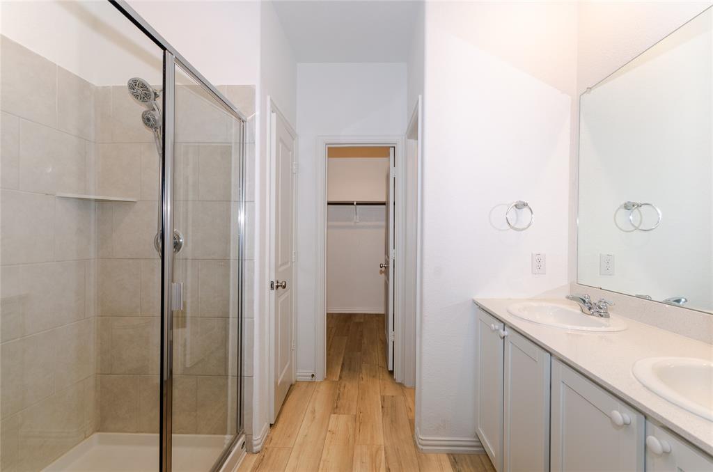 1222 Sequoia Lane Princeton, TX 75407 - Photo 13 of 29 Full bath with a shower stall, double vanity, wood finished floors, and a walk in closet