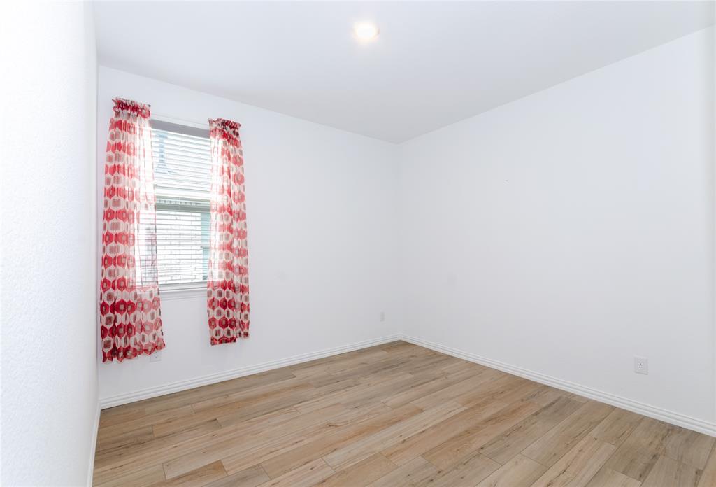 1222 Sequoia Lane Princeton, TX 75407 - Photo 20 of 29 Bedroom #2 featuring light wood finished floors and baseboards