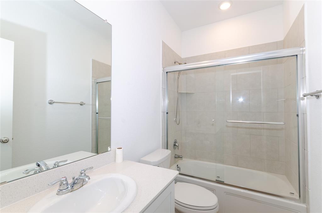 1222 Sequoia Lane Princeton, TX 75407 - Photo 21 of 29 Full bath featuring toilet, vanity, combined bath / shower with glass door, and recessed lighting