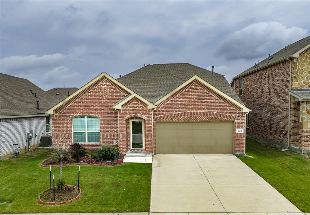 1222 Sequoia Lane Princeton, TX 75407 - Photo 27 of 29 Traditional-style house featuring roof with shingles, a garage, brick siding, central AC, and concrete driveway