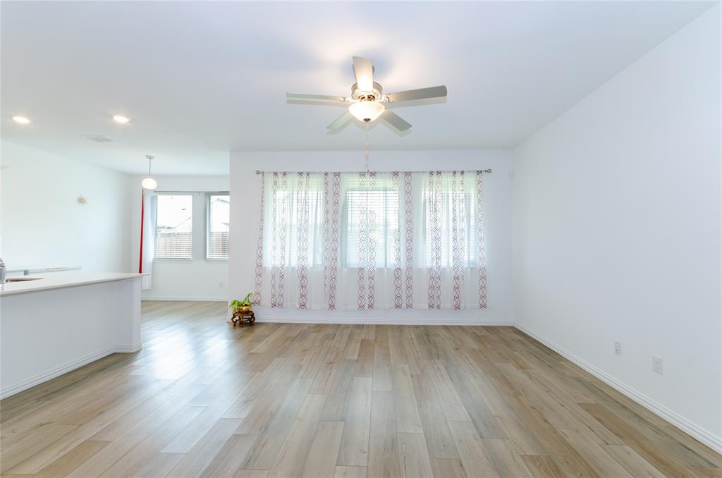 1222 Sequoia Lane Princeton, TX 75407 - Photo 8 of 29 Living room with a ceiling fan, light wood-type flooring, baseboards, recessed lighting, and a sink