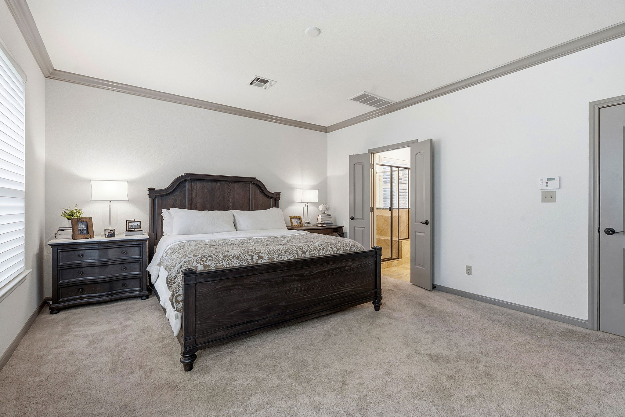 12321 Edenvale Path Austin, TX 78732 - Photo 15 of 36 A tranquil primary bedroom located downstairs.