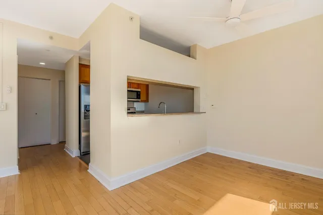 a view of empty room with wooden floor
