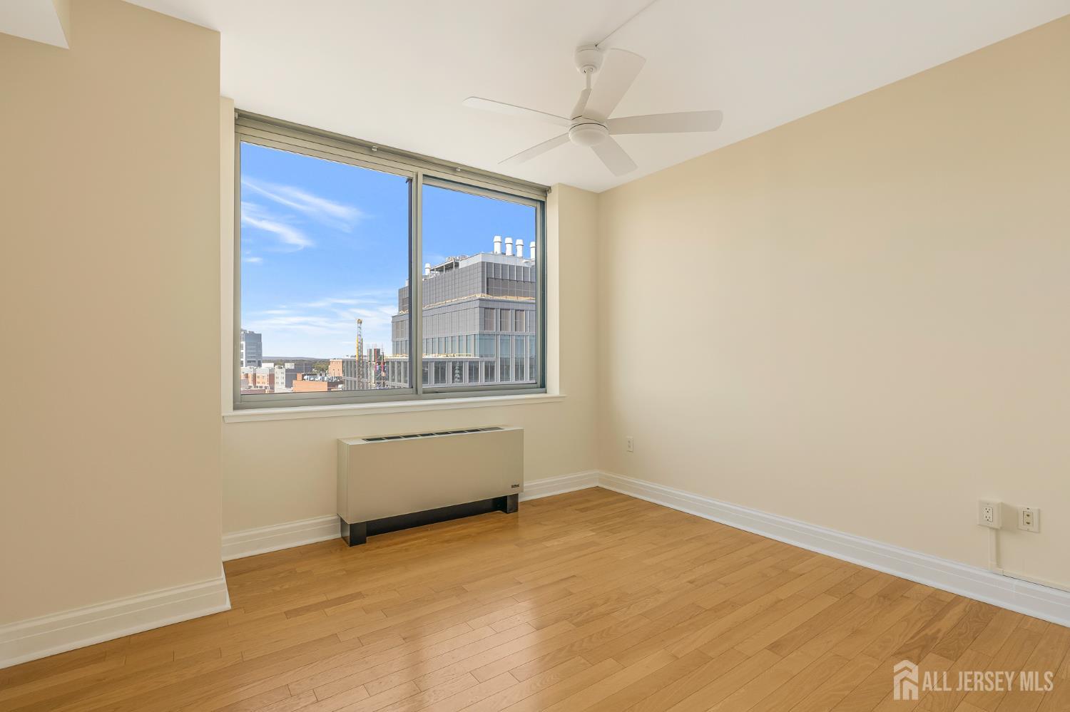 1 Spring Street, Unit 1704 New Brunswick, NJ 08901 - Photo 18 of 44 a view of an empty room with a window
