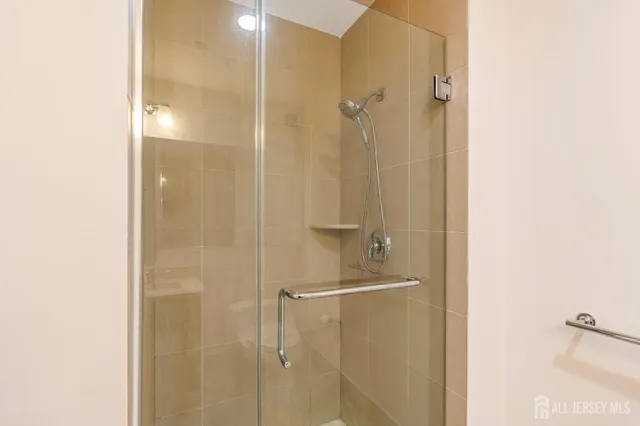 a bathroom with a glass shower door