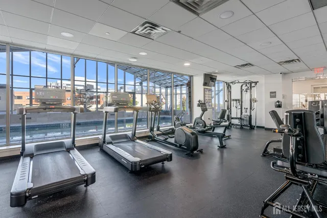 a room with gym equipment and a large window