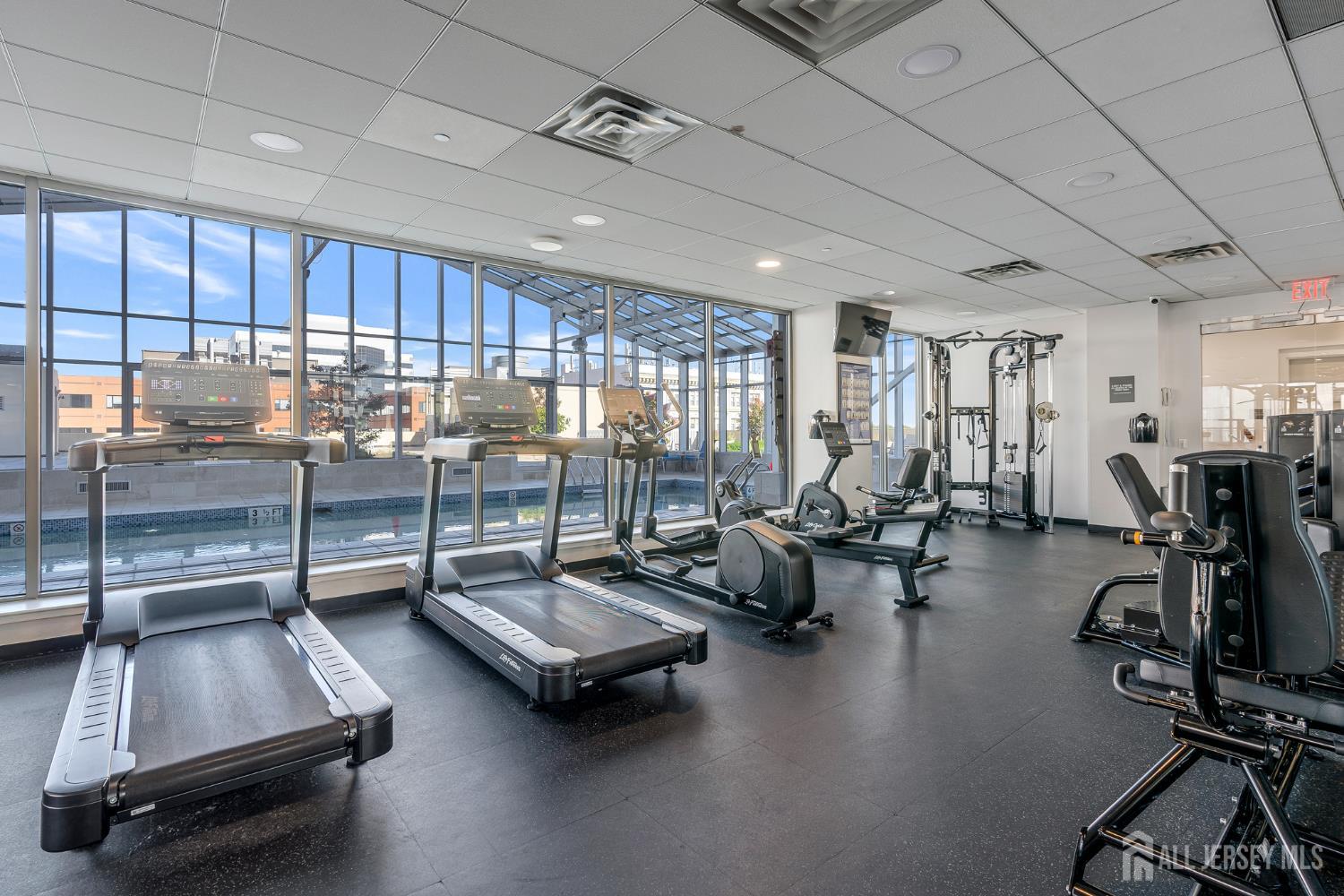 1 Spring Street, Unit 1704 New Brunswick, NJ 08901 - Photo 30 of 44 a room with gym equipment and a large window