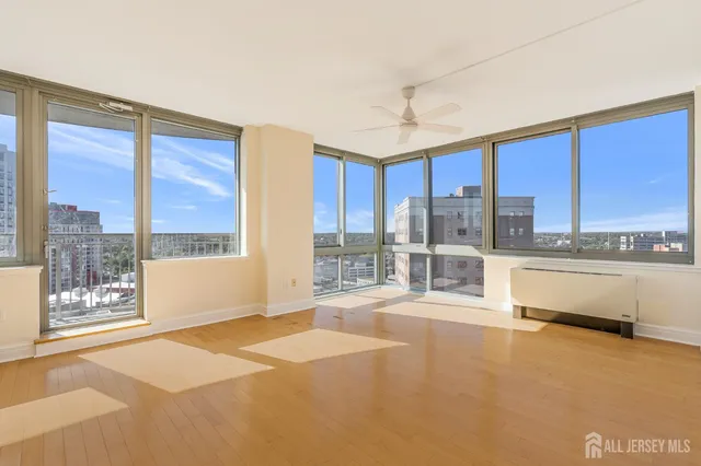 a large kitchen with kitchen island a large window a sink and cabinets