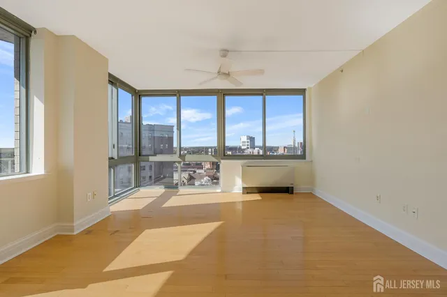 a living room with a large window and furniture