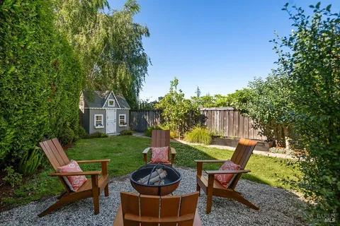 a backyard of a house with outdoor seating
