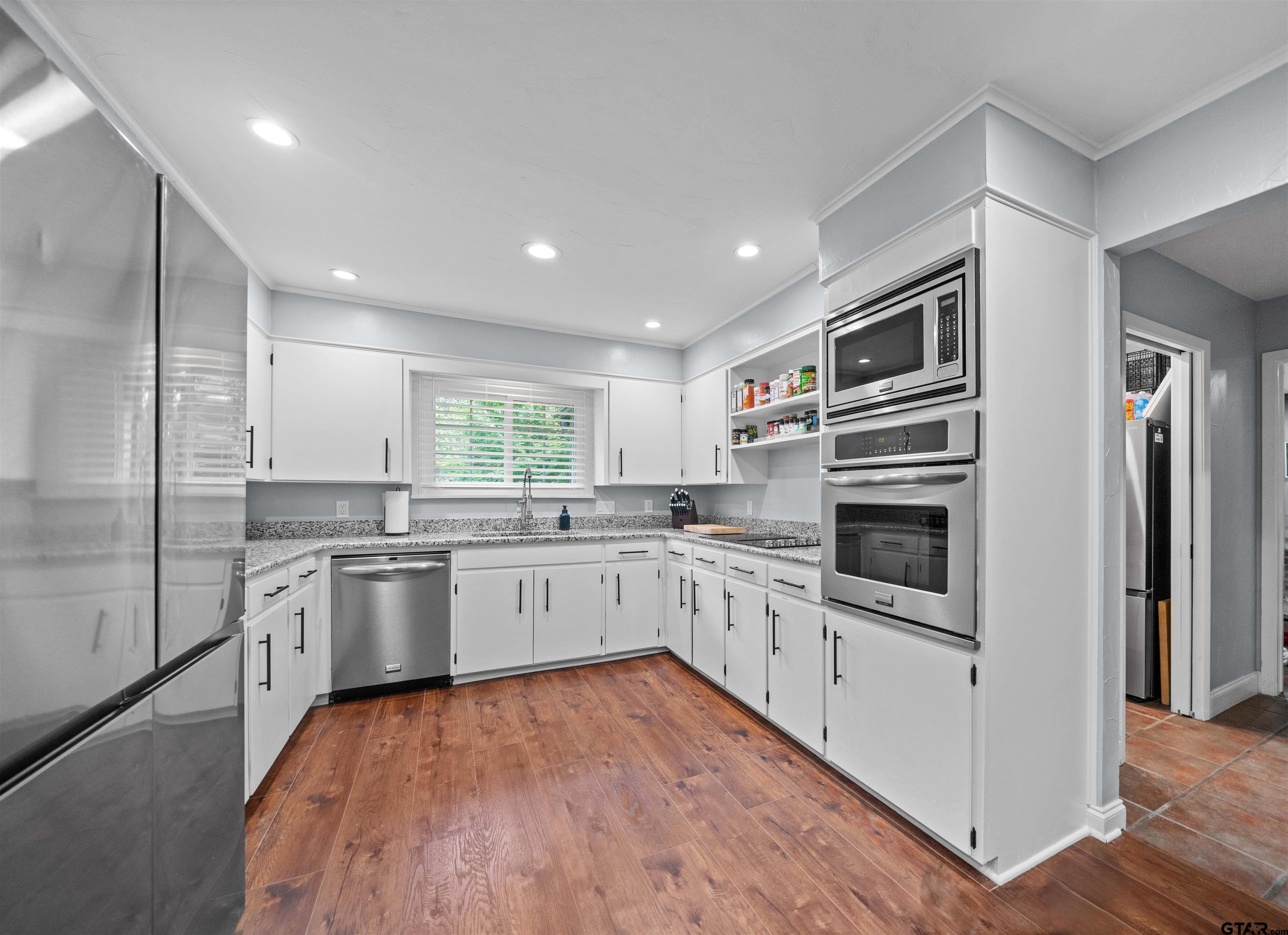 4107 Chester Drive Tyler, TX 75701 - Photo 11 of 45 a kitchen with stainless steel appliances granite countertop a refrigerator and a stove top oven